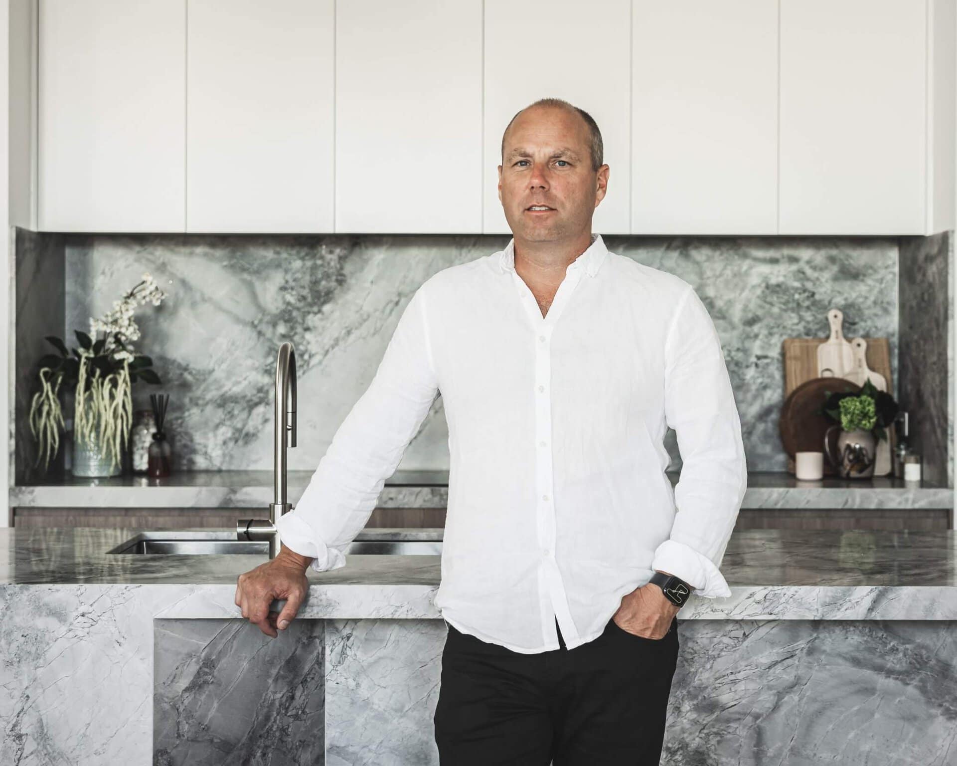 Damian Clancy standing in front of marble kitchen island