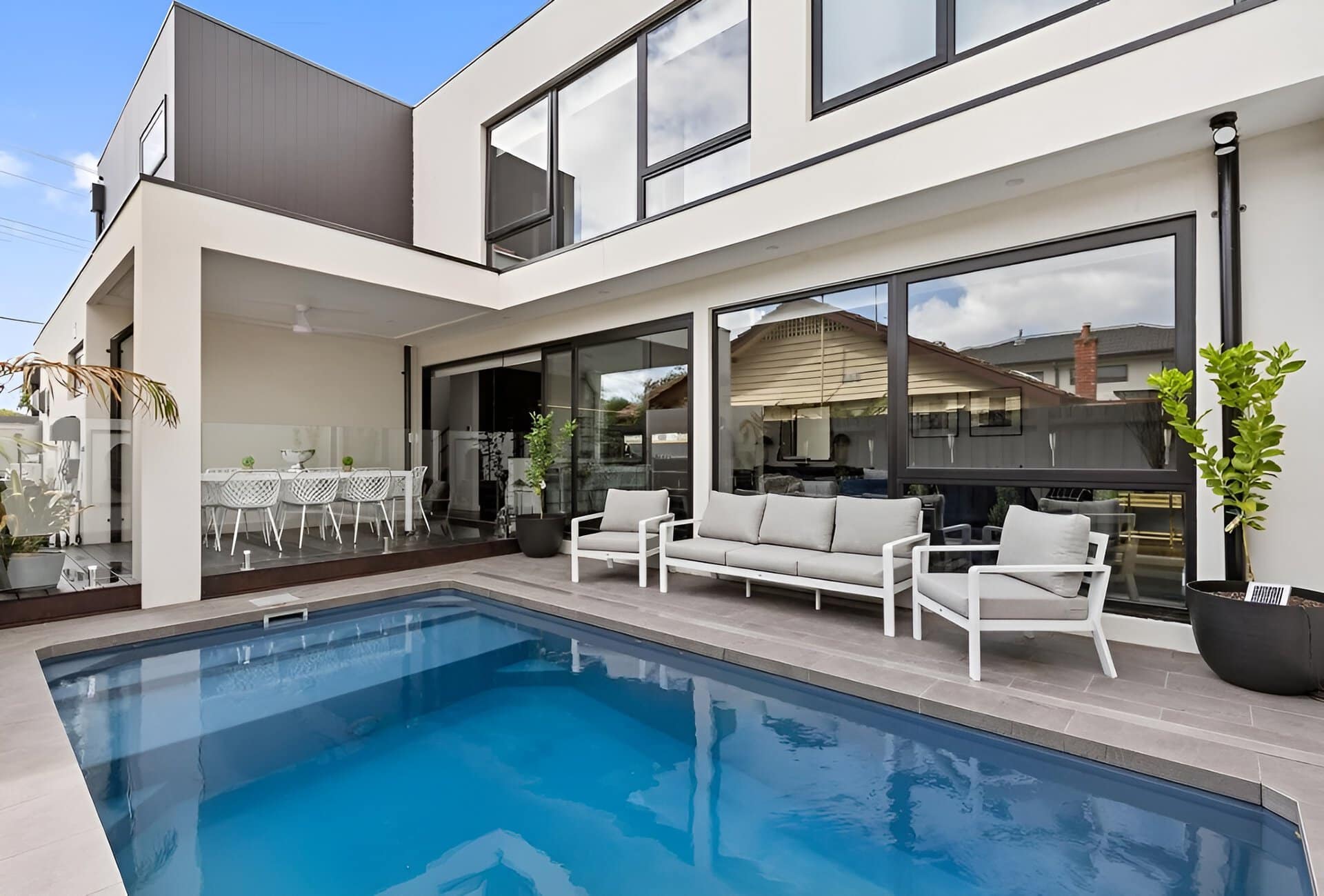 Outdoor courtyard with swimming pool, tiled patio, and covered alfresco dining area